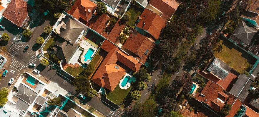 Aerial view of houses, backyards and pools